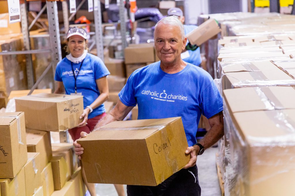 Volunteer holding a box of food